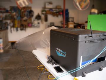 Aeroseal machine on a table in a workshop.