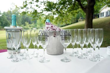Wedding champagne glasses and bottle on table.