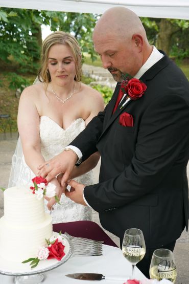 Bride and groom cutting their wedding cake together.