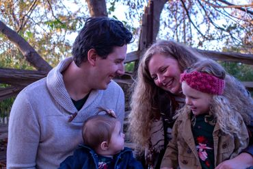 A joyful family sharing a moment outdoors in autumn.