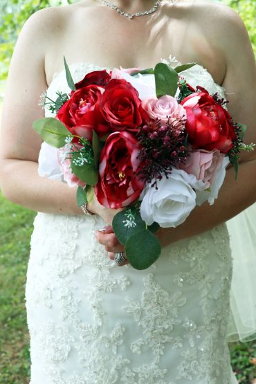 Bride holding a vibrant floral bouquet.