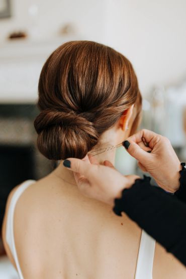 Woman with an elegant low bun hairstyle from the back.
