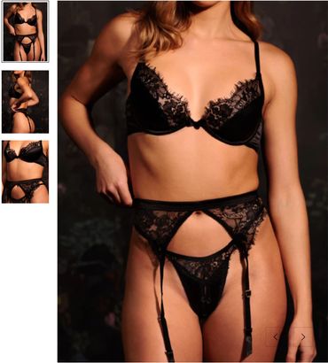 Woman in black lace lingerie set with garter belt.