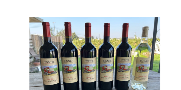 Bottle of the first five Jenner Family Estates Zinfandel vintages with a bottle of 2022 Opal's Table