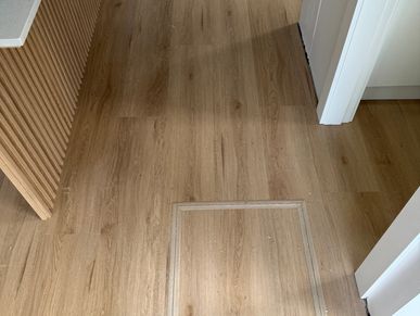 Hybrid Floorboards with a custom made manhole cut out, finished with trims 