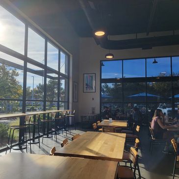 Bright and airy café with large windows and wooden tables.