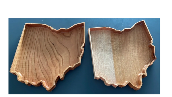 Two examples of approx. 7"x7" (18 cm x 18 xm) State of Ohio catchall trays. On the left, cherry wood