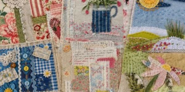 A detailed fabric patchwork with floral and landscape designs.