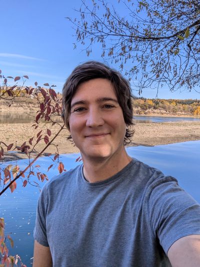 Joey Shaughnessy, MSW, RSW outside by the river on a walk & talk therapy session. 