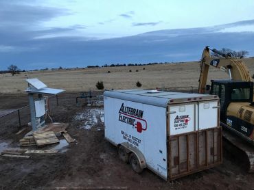 Mobile electrical trailer at a rural site during dusk.