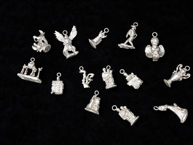 Silver vintage charm collection with various detailed designs on black background.