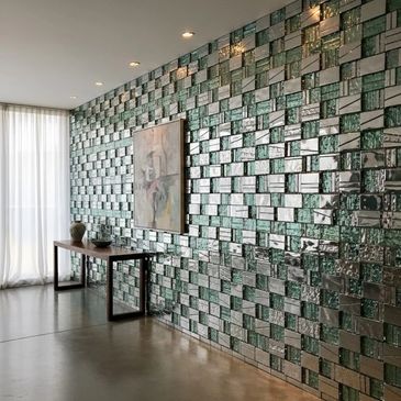 Modern hallway with reflective, textured wall tiles and minimalist decor.