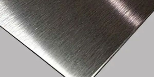 Close-up of a brushed metal sheet corner.