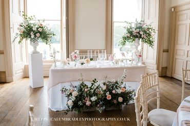 Elegant wedding table setup with flowers.