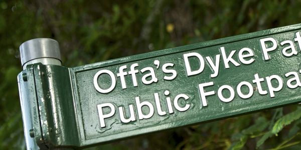 Offa’s Dyke Path. Public Footpath sign. White writing on a green iron finger post sign.