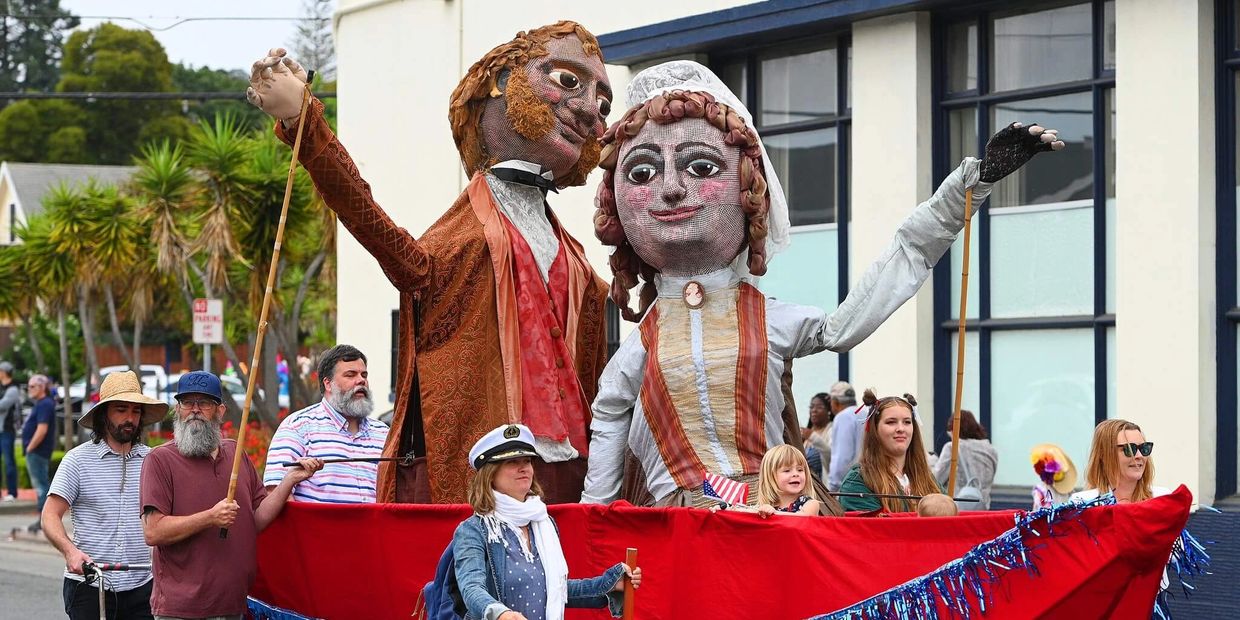 Giant puppets of General Vallejo and his wife Benicia being led down the street during the parade.