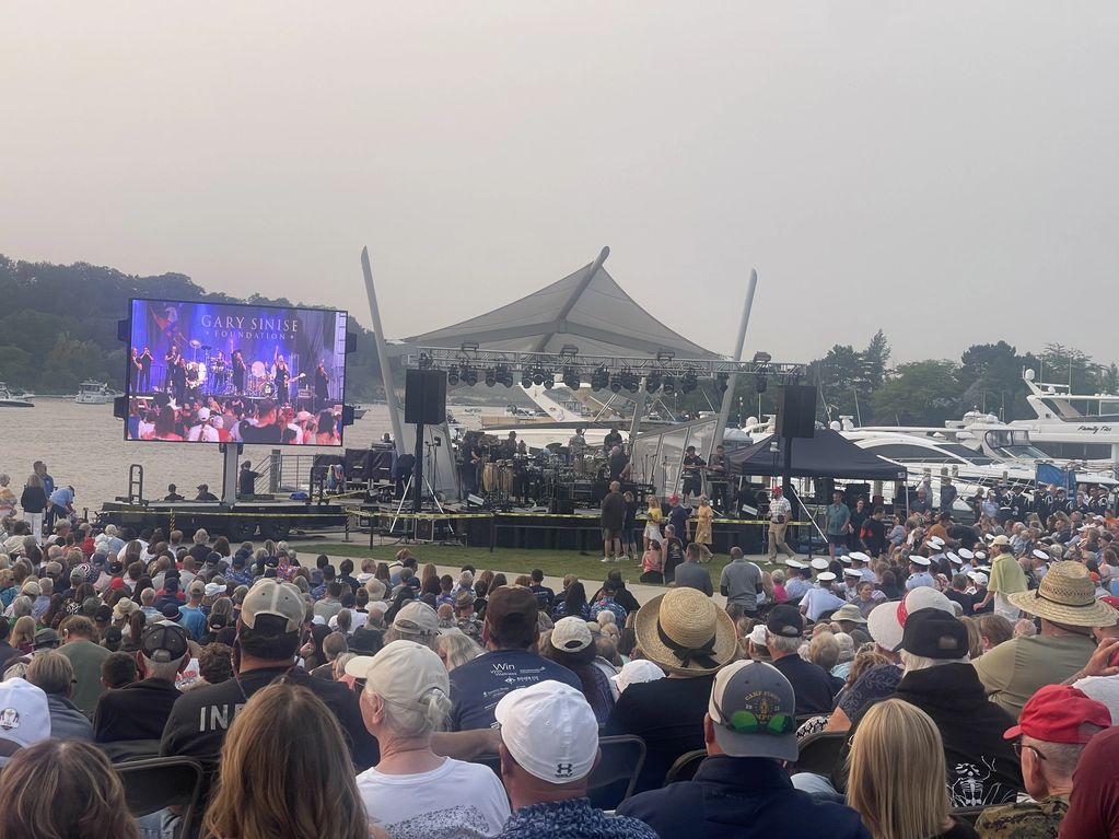 Crowd gathered for a Gary Sinise Foundation outdoor concert by the waterfront.