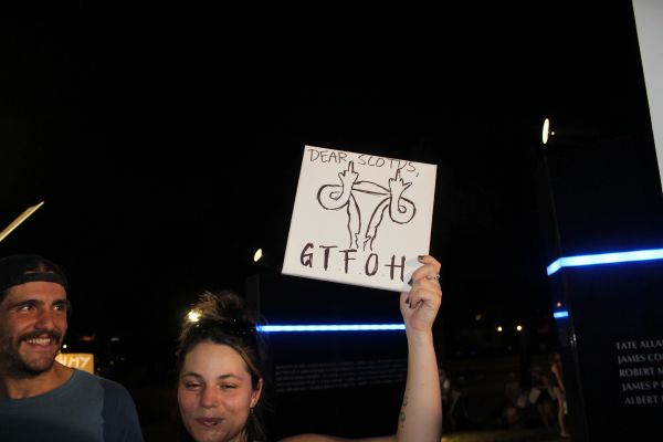 Person holding a protest sign with a message to SCOTUS.