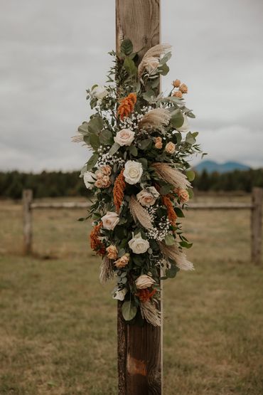 Beige, blush, and bronze boho wedding arch flowers