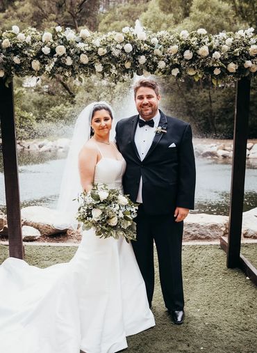 White wedding flowers on top of rectangle arch