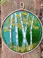 Stained glass artwork featuring white birch trees with yellow leaves.