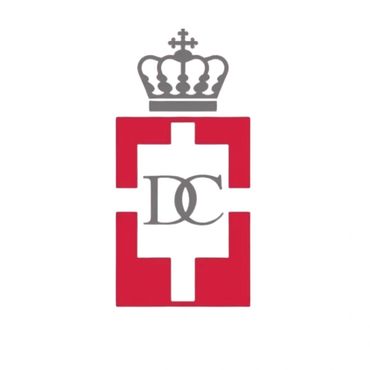 Logo with a crown, red geometric shape, and intertwined letters DC.