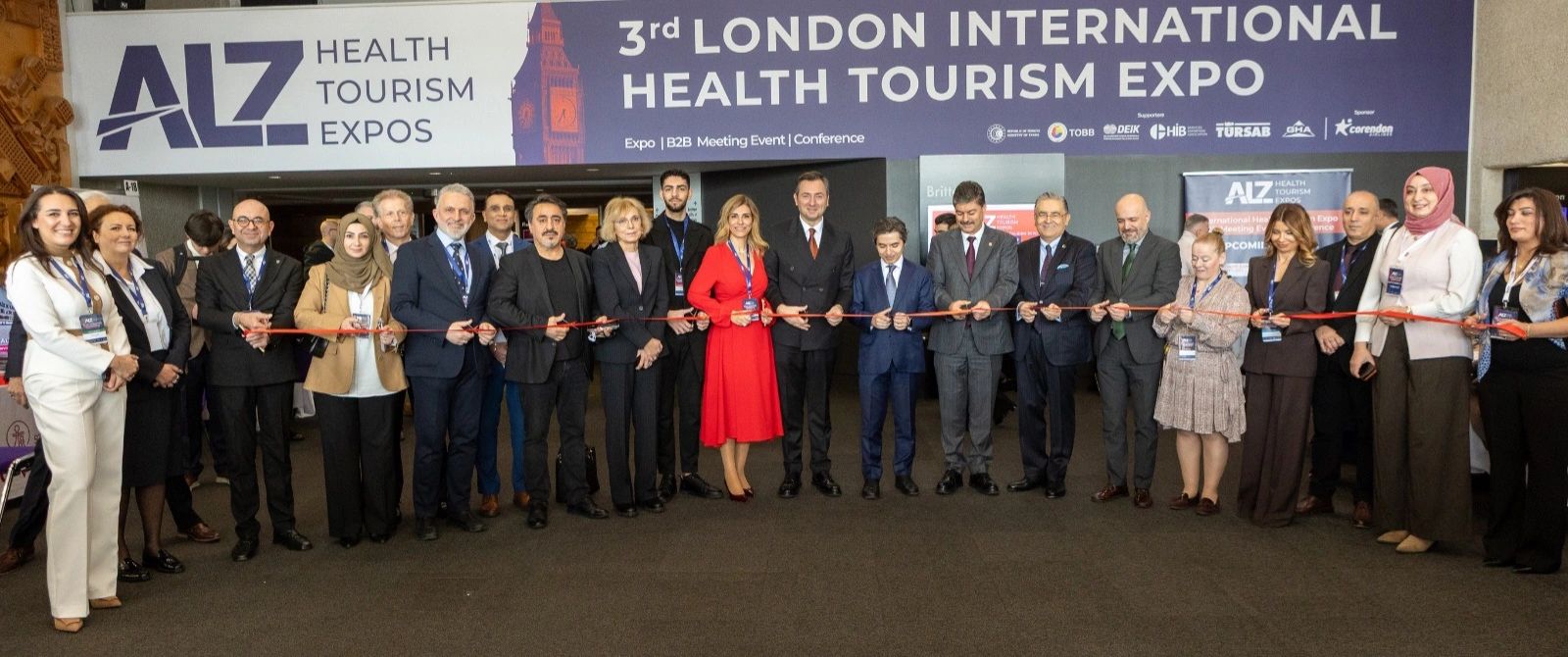 Group of professionals cutting ribbon at 3rd London International Health Tourism Expo.
