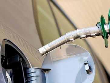 Filling a car with gasoline.