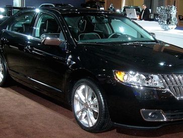 A shiny black Lincoln MKZ sedan.