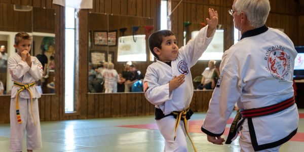  A Little Dragon demonstrating a palm heel attack to his Karate instructor.