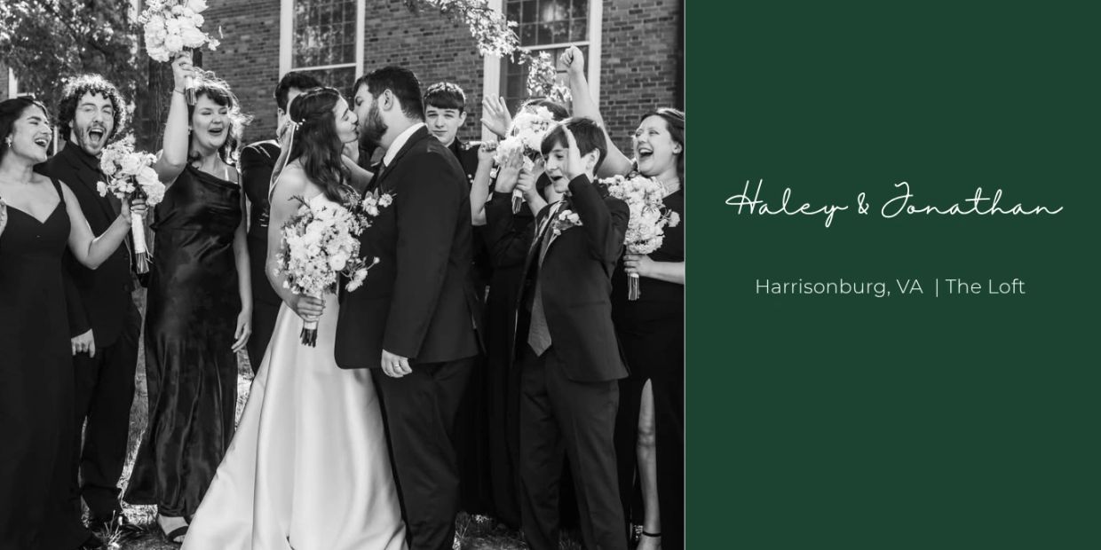 Black and white photo of a wedding kiss with joyous bridal party celebrating.
