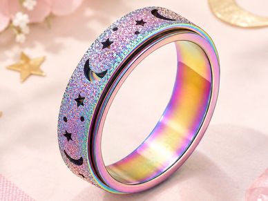 Colorful glittery ring with moon and star cutouts.