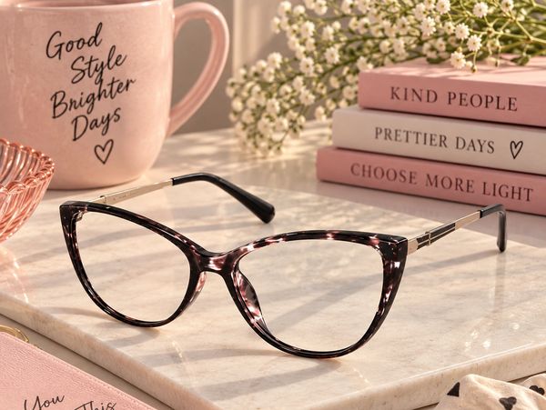 Stylish tortoiseshell eyeglasses on a marble surface.