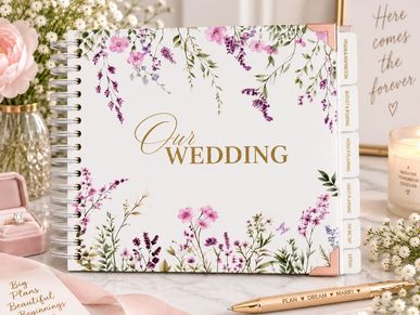 Floral wedding planner book with gold text.
