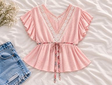Pink blouse with lace and floral waist tie.