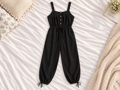 Black sleeveless jumpsuit with buttons.