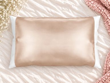Silky beige pillowcase on white pillow.
