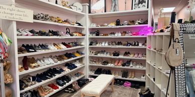 Room full of women's shoes neatly arranged on shelves.