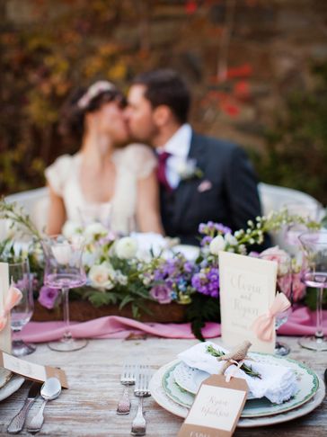 Bride and Groom kissing behind sweetheart table