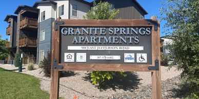 Granite Springs Apartments. An image of a cream, blue,  and brown apartment complex. 