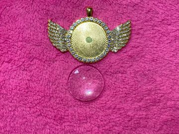 Winged circle. Gold.