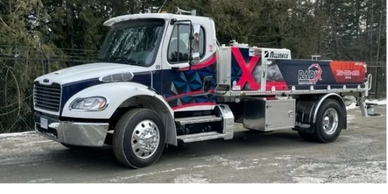 A customized white and blue truck with colorful graphics parked outdoors.