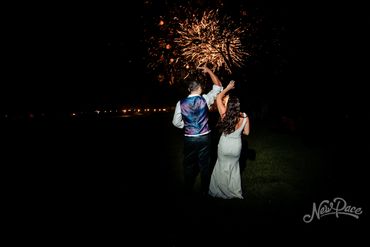 Fireworks behind bride and groom
