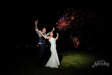 Fireworks behind bride and groom