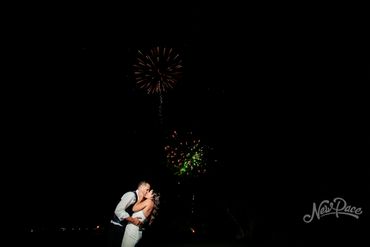 Fireworks behind bride and groom