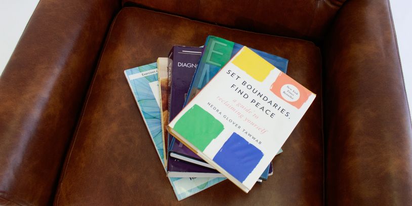 Stack of books on a leather chair