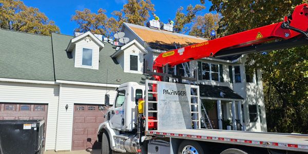 Boom Truck for roofing projects, Able to load materials onto roof and minimize traffic over roof