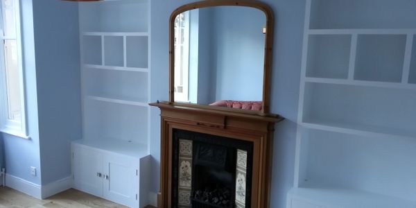 Bespoke cupboards, alcove, and shelving.