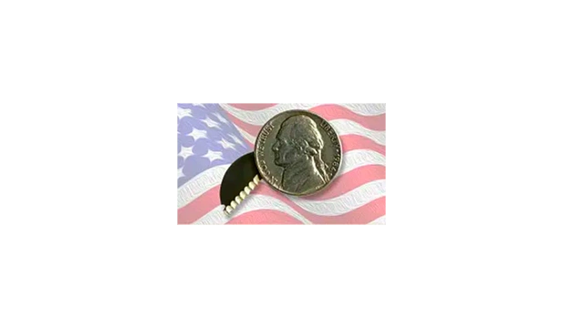American flag background. U.S. nickel with a secret knife blade inside. 