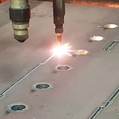 Steel plate being flame cut by CNC machine. Done in Becker Welding shop in Cincinnati Ohio
